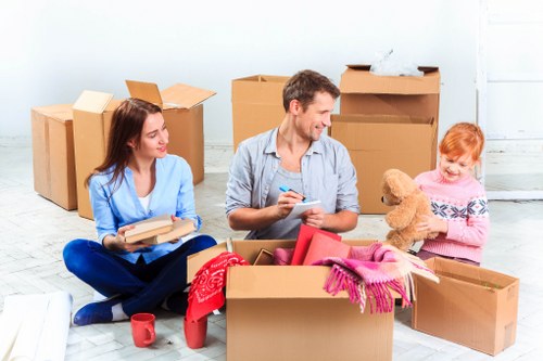 Packed moving boxes and furniture ready for local transport