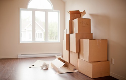 Movers carrying furniture through a narrow stairwell