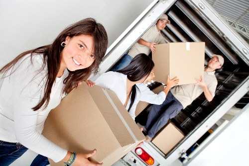 Packed moving boxes and wrapped furniture ready for local transport